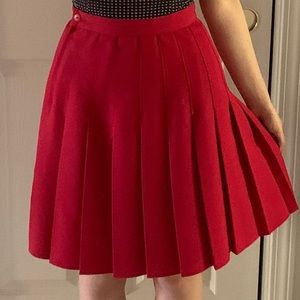 pleated red skirt with button and zipper at side